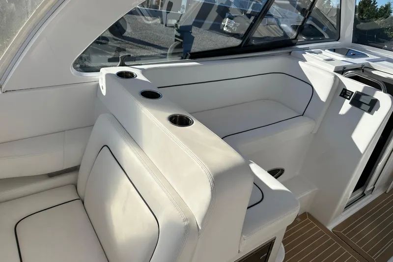  Yacht Photos Pics 2020 Southport 33DC boat interior with white seating and cup holders.