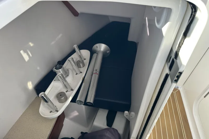  Yacht Photos Pics Interior of a 2020 Southport 33DC boat showing storage area with metal fixtures.