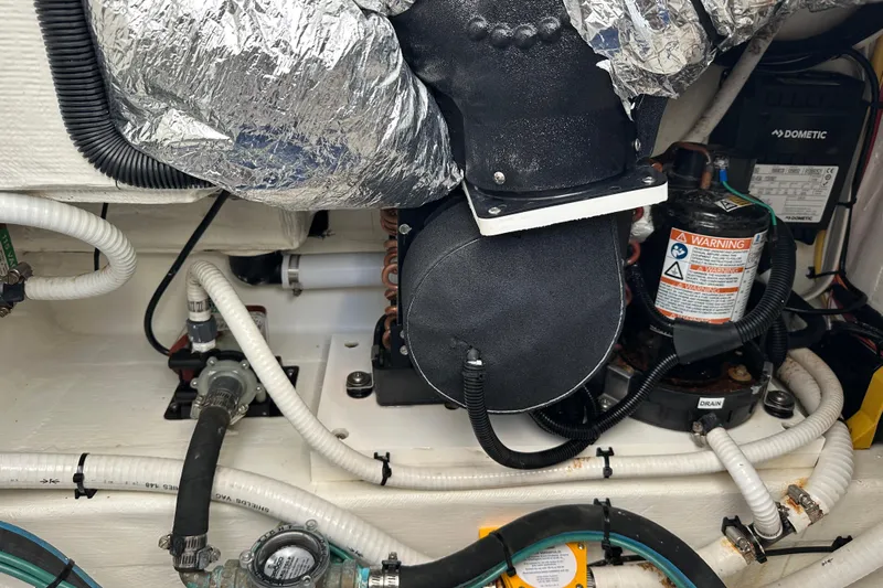  Yacht Photos Pics Engine compartment of a 2020 Southport 33DC boat with various mechanical components.