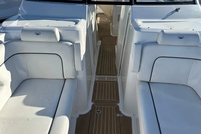  Yacht Photos Pics 2020 Southport 33DC boat interior with white seating and wooden flooring.