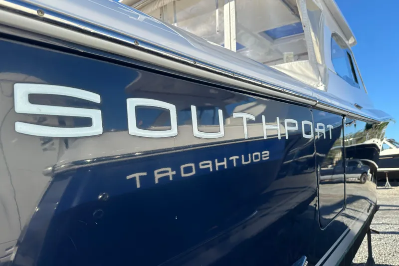 Yacht Photos Pics 2020 Southport 33DC boat with sleek blue exterior and reflective lettering.