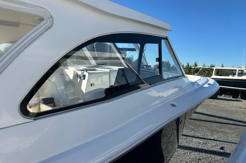  Yacht Photos Pics 2020 Southport 33DC boat side view with sleek design and clear windows.