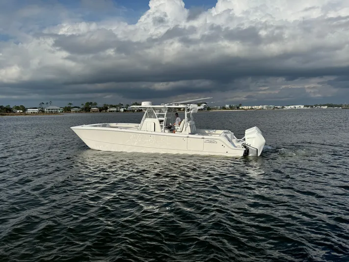 Yacht Photos Pics 2022 Invincible 35 Catamaran on calm waters under cloudy sky.
