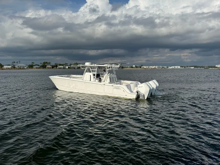  Yacht Photos Pics 2022 Invincible 35 Catamaran on open water under cloudy skies.