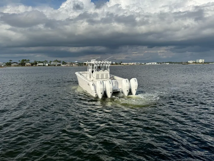 Yacht Photos Pics 2022 Invincible 35 Catamaran cruising on a cloudy day.