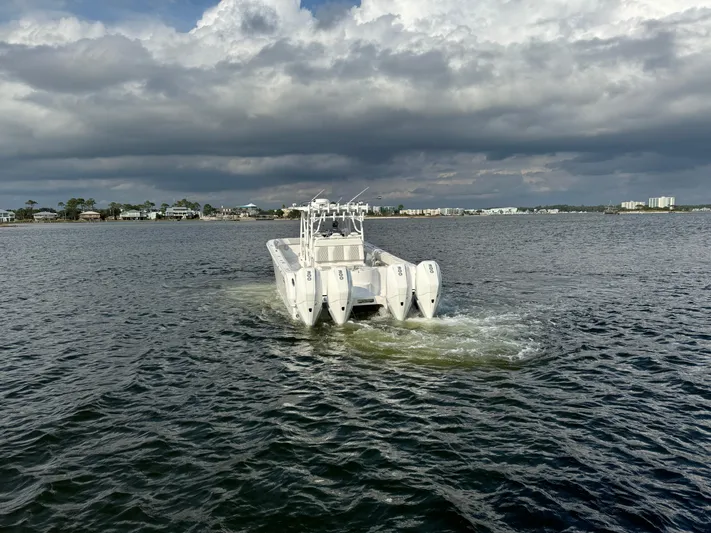  Yacht Photos Pics Invincible 35 Catamaran 2022 cruising on a cloudy day in open water.