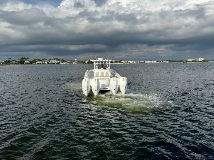  Yacht Photos Pics Invincible 35 Catamaran 2022 cruising on a cloudy day in open water.
