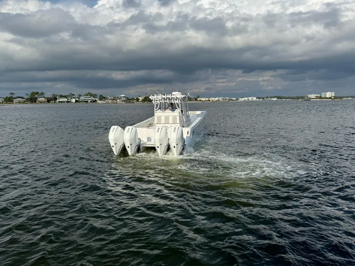  Yacht Photos Pics Invincible 35 Catamaran 2022 cruising on open water under cloudy skies.