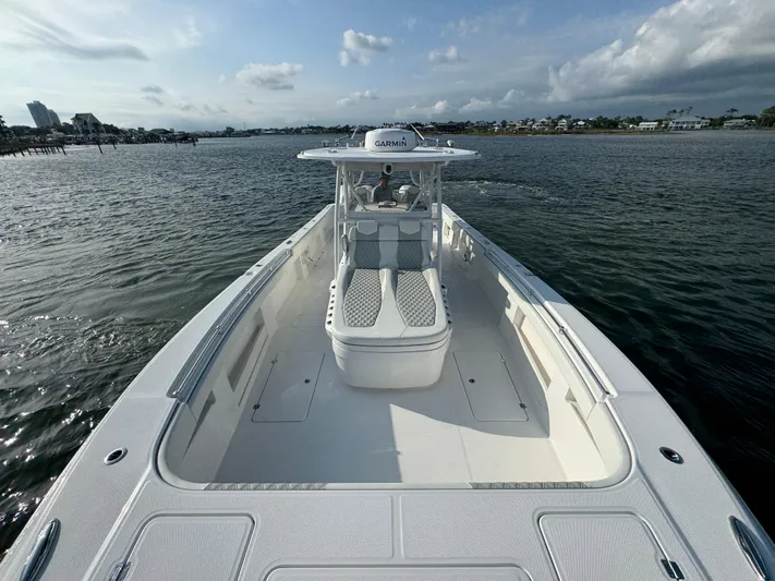  Yacht Photos Pics 2022 Invincible 35 Catamaran on calm waters, showcasing spacious deck and sleek design.