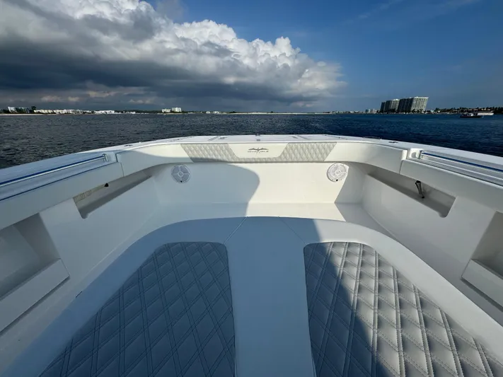  Yacht Photos Pics 2022 Invincible 35 Catamaran on calm waters under a cloudy sky.