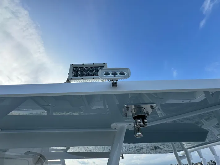  Yacht Photos Pics 2022 Invincible 35 Catamaran roof detail with mounted lights against blue sky.