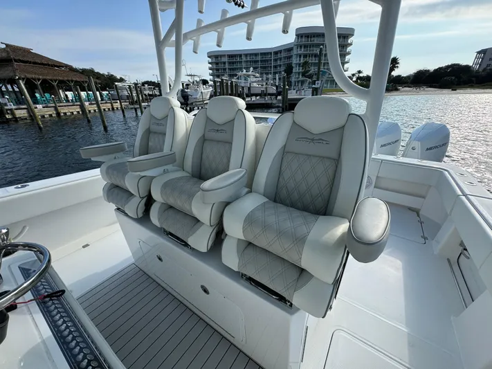  Yacht Photos Pics Luxury seating on 2022 Invincible 35 Catamaran, docked at marina.