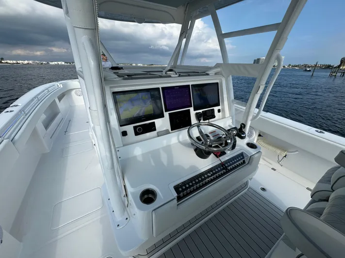  Yacht Photos Pics 2022 Invincible 35 Catamaran helm with dual screens and steering wheel on open water.