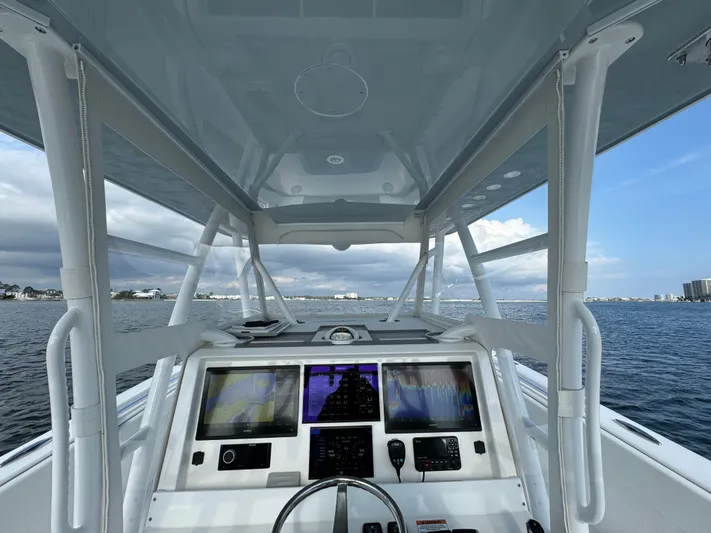  Yacht Photos Pics 2022 Invincible 35 Catamaran helm with advanced navigation systems on open water.