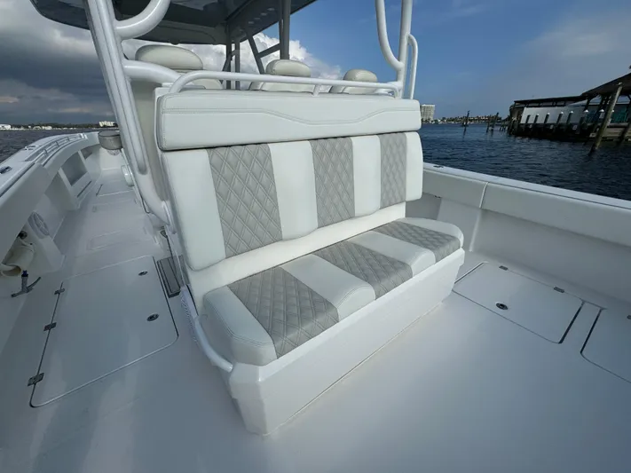  Yacht Photos Pics Invincible 35 Catamaran 2022, luxurious seating, white and gray upholstery, docked by the water.