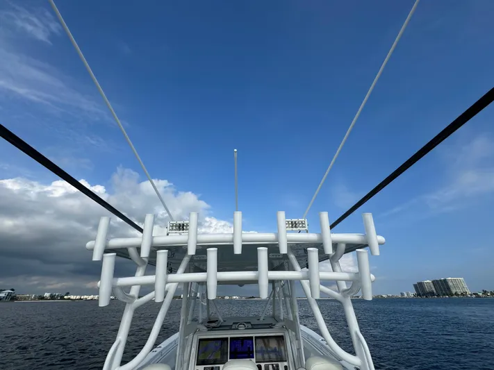  Yacht Photos Pics Invincible 35 Catamaran 2022 on water, view from helm, clear sky, coastal backdrop.