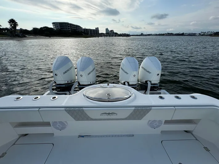  Yacht Photos Pics Invincible 35 Catamaran 2022 with four Mercury engines on a calm water backdrop.