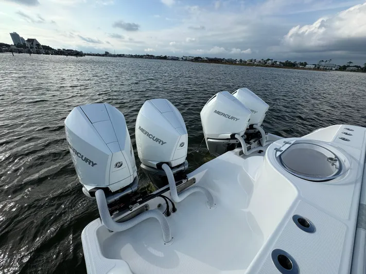  Yacht Photos Pics 2022 Invincible 35 Catamaran with triple Mercury outboard engines on water.