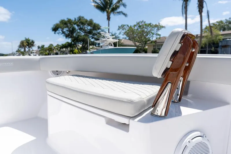  Yacht Photos Pics 2022 Jupiter 32 boat interior with white cushioned seating and polished wood accents.