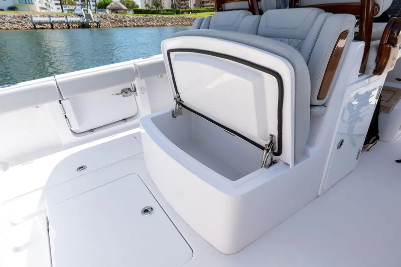  Yacht Photos Pics 2022 Jupiter 32 boat with open storage compartment on deck, near water.