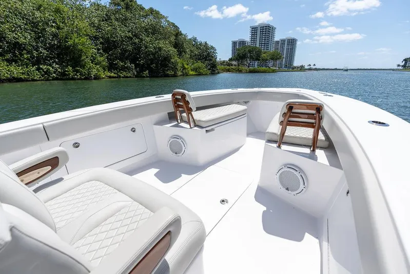  Yacht Photos Pics Luxurious 2022 Jupiter 32 boat interior with seating, speakers, and scenic waterfront view.