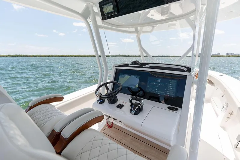  Yacht Photos Pics Helm of 2022 Jupiter 32 boat with modern controls on open water.