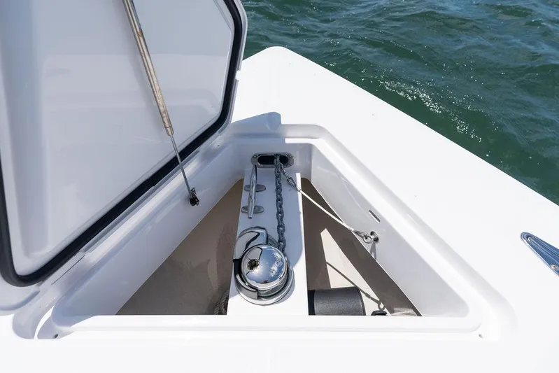  Yacht Photos Pics Anchor compartment on 2022 Jupiter 32 boat, open hatch, chain visible, ocean background.