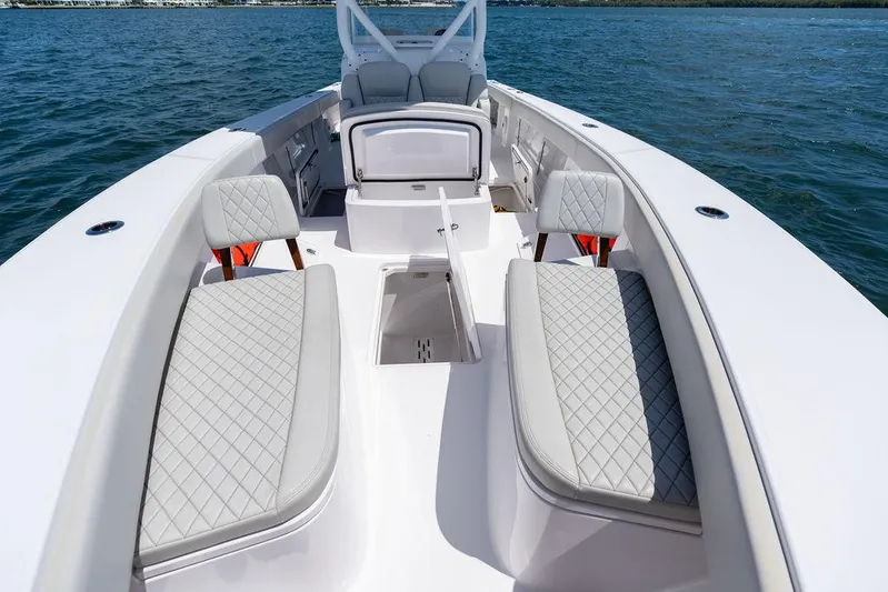  Yacht Photos Pics 2022 Jupiter 32 boat interior with cushioned seating on open water.