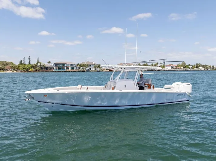  Yacht Photos Pics 2022 Jupiter 32 boat cruising on a sunny day near waterfront homes.