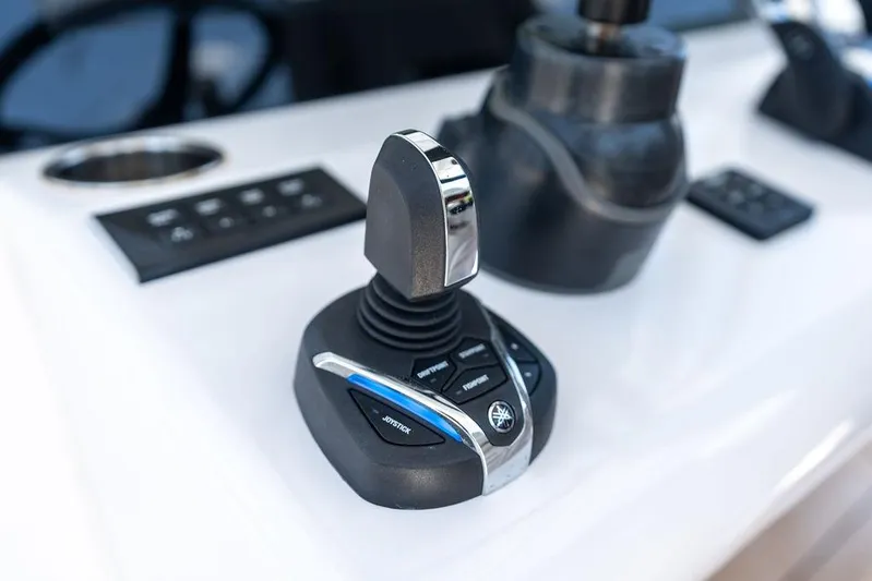  Yacht Photos Pics Joystick control on a 2022 Jupiter 32 boat dashboard, featuring modern navigation technology.