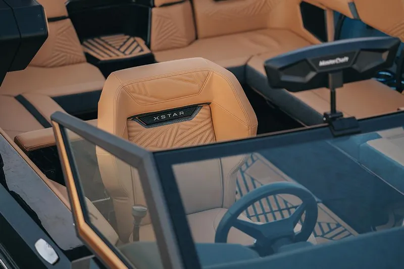  Yacht Photos Pics Manufacturer Provided Image: 2025 MasterCraft XStar 23 boat interior with tan leather seats and steering wheel.