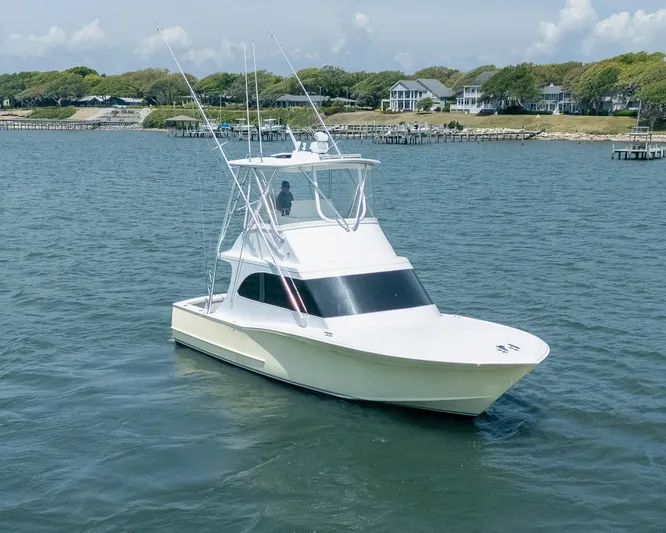  Yacht Photos Pics Custom Express 2013 boat on calm water near shoreline with houses in the background.