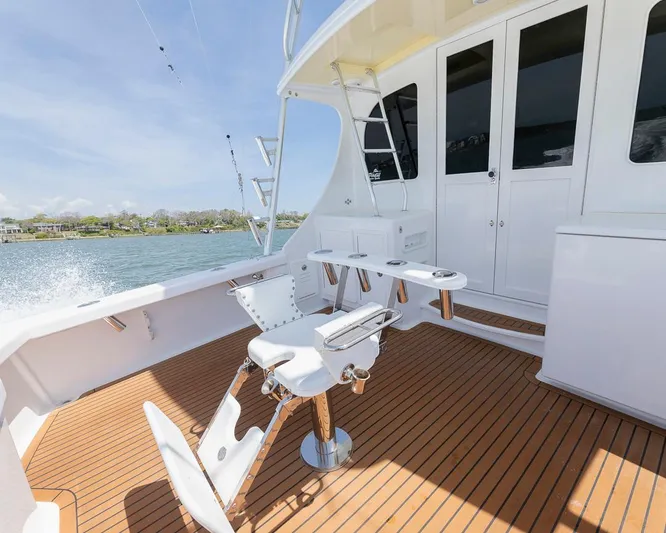  Yacht Photos Pics Custom Express 2013 boat deck with fishing chair and rod holders on teak flooring.