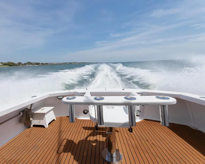  Yacht Photos Pics Custom Express 2013 boat cruising on open water, leaving a wake behind.