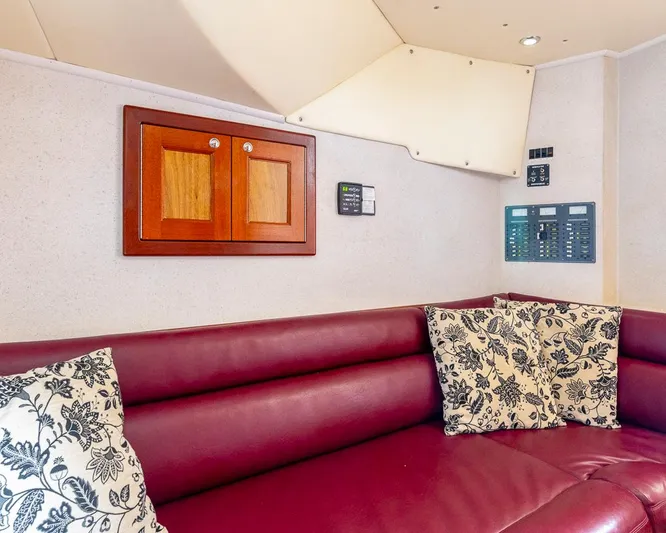  Yacht Photos Pics Luxurious maroon leather seating with floral cushions in a 2013 Custom Express interior.