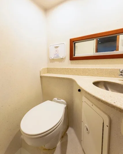  Yacht Photos Pics Compact bathroom with toilet, sink, and mirror in a 2013 Custom Express model.