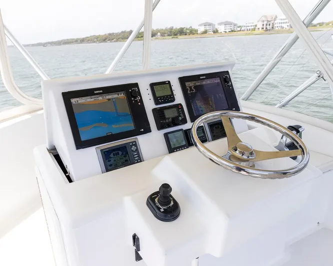  Yacht Photos Pics Boat helm with navigation screens, steering wheel, and controls on a 2013 Custom Express.