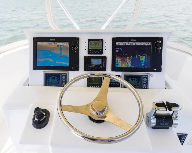  Yacht Photos Pics Boat control panel with navigation screens, steering wheel, and throttle on a 2013 Custom Express.