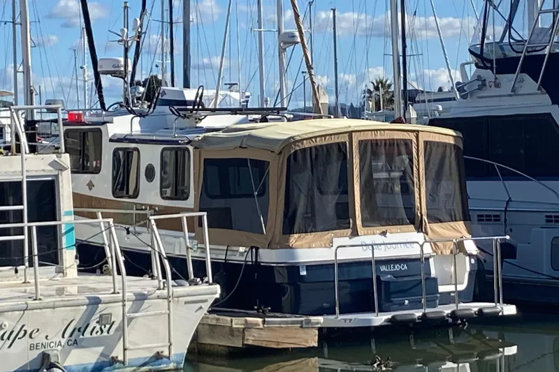 Belle Journee Yacht Photos Pics 2013 Ranger Tugs R-29 S boat docked at a marina under a clear blue sky.