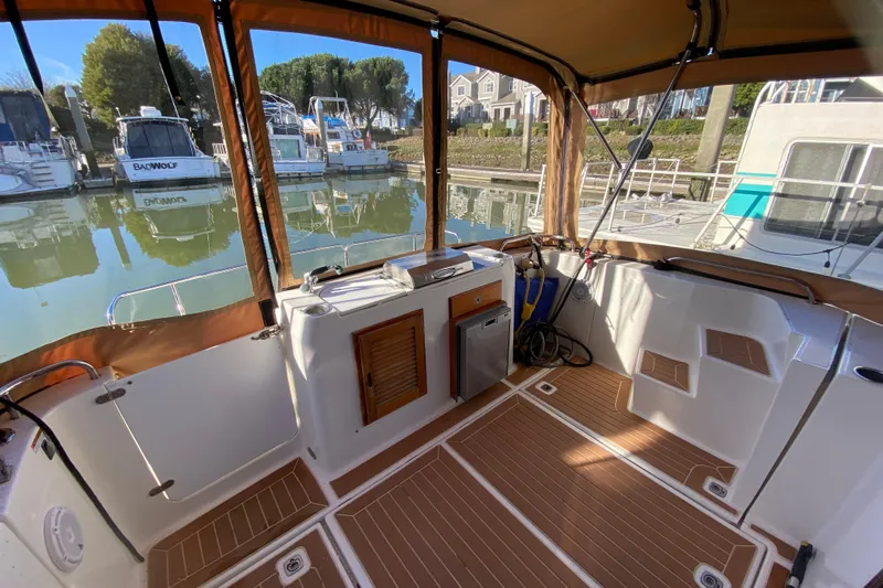 Belle Journee Yacht Photos Pics 2013 Ranger Tugs R-29 S boat interior with wood flooring and marina view.