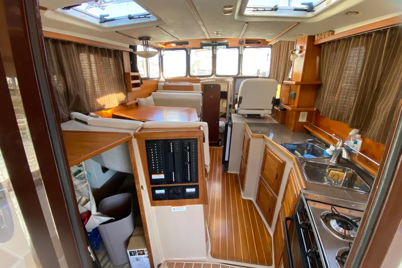 Belle Journee Yacht Photos Pics Interior of 2013 Ranger Tugs R-29 S boat with kitchen and seating area.