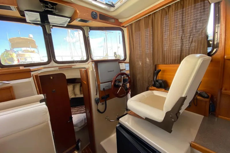 Belle Journee Yacht Photos Pics 2013 Ranger Tugs R-29 S interior with helm, seating, and navigation equipment.
