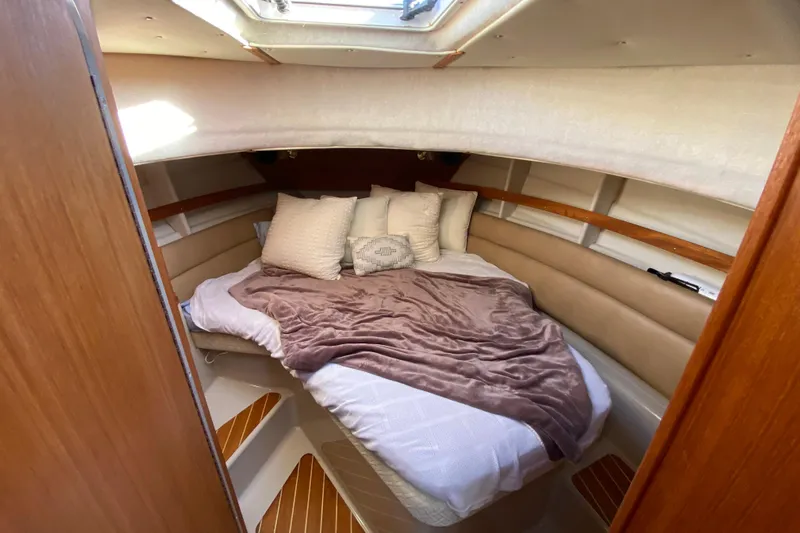 Belle Journee Yacht Photos Pics Cozy cabin interior of 2013 Ranger Tugs R-29 S with plush bedding and natural light.