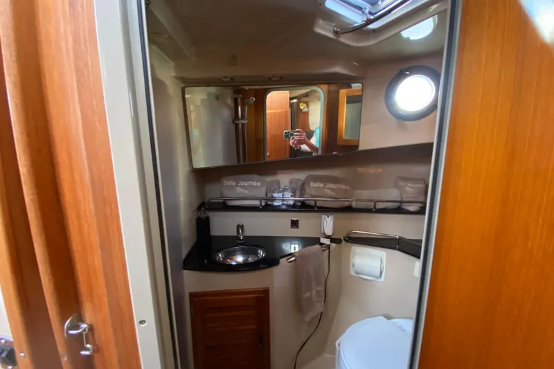 Belle Journee Yacht Photos Pics 2013 Ranger Tugs R-29 S bathroom with sink, mirror, and porthole window.