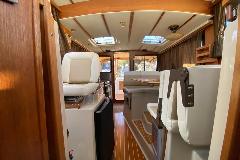 Belle Journee Yacht Photos Pics Interior of 2013 Ranger Tugs R-29 S boat with seating and wood accents.