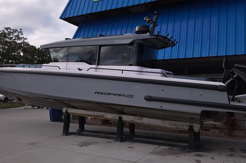 Hell Or High Waters Yacht Photos Pics 2024 Axopar 37XC CROSS CABIN boat displayed outdoors on a stand.