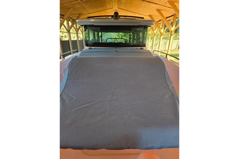 Hell Or High Waters Yacht Photos Pics 2024 Axopar 37XC CROSS CABIN under wooden shelter, front view with covered deck.