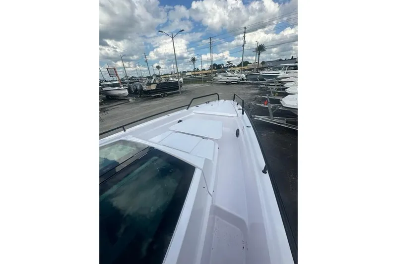 Hell Or High Waters Yacht Photos Pics 2024 Axopar 37XC CROSS CABIN boat on display at a marina under cloudy skies.