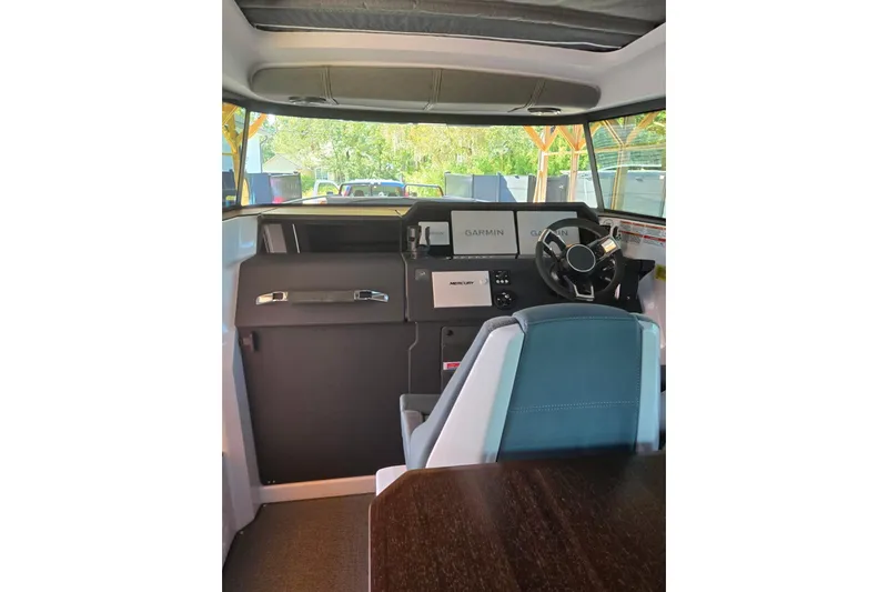 Hell Or High Waters Yacht Photos Pics 2024 Axopar 37XC CROSS CABIN interior with Garmin navigation and modern steering.