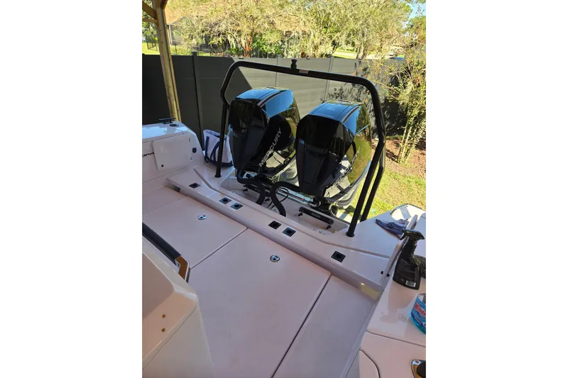 Hell Or High Waters Yacht Photos Pics 2024 Axopar 37XC CROSS CABIN with dual Mercury outboard engines, docked outdoors.